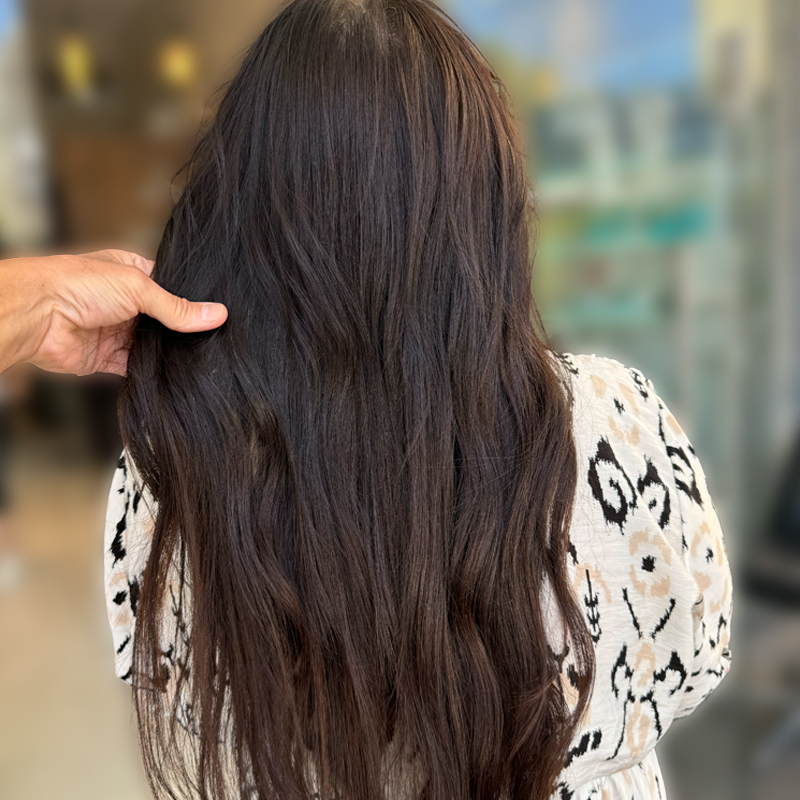 genius weft hair extensions on client