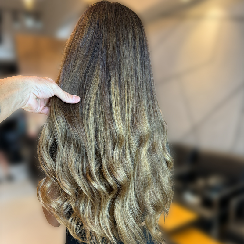 tape in hair extensions on client